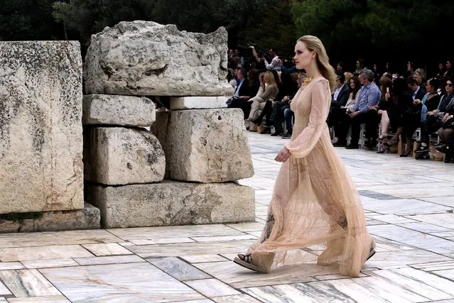 A model presents a creation by Greek designer Vassilios Kostetsos, who presented his Spring-Summer collection “Narcissus” during a fashion show that took place at the entrance of the ancient Odeon of Herodes Atticus in Athens, Greece, 31 March 2018, as part of the Athens Xclusive Designers Week. (Photo by Simela Pantzartzi/EPA/EFE)