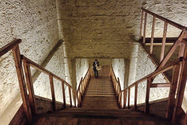 A tourist walks inside the newly opened Tomb of Pharaoh Amenhotep III in Luxor, Egypt, 04 October 2025. The tomb, first discovered around 1799, was opened to the public on 04 October following two decades of restoration led by UNESCO. (Photo by EPA/EFE/Stringer)