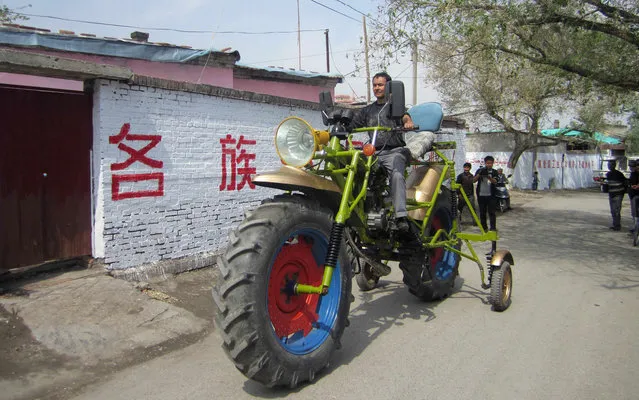 An ethnic Uighur man Abulajon drives his self-made motorcycle during a test in Manas county, Xinjiang Uighur autonomous region, April 27, 2013. Abulajon, a 30-year-old Uighur worker from a sewage treatment plant, spent a year making his 0.3 tonnes motorcycle measuring 4.3 metres (14 feet) in length and 2.4 metres (7.8 feet) in height, although it makes it impossible for him to drive it on the street. It cost him about 8000 yuan ($1300) to buy all the parts from salvage stations and the converted engine can power the motorcycle with a speed of 40 km per hour (24.8 miles per hour), local media reported. (Photo by Reuters/China Daily)