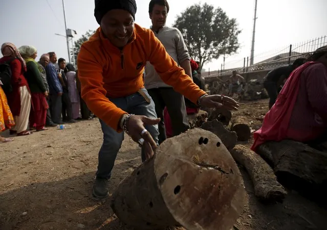 A man buys firewood from a government depot after the government started selling it from Sunday, as a respite for the ongoing fuel and cooking gas shortages in Kathmandu, Nepal November 16, 2015. The middle hills and the capital Kathmandu have suffered fuel and cooking gas shortages after protesters in the south switched to blocking supplies from India, Nepal's largest trading partner, almost two months ago. (Photo by Navesh Chitrakar/Reuters)