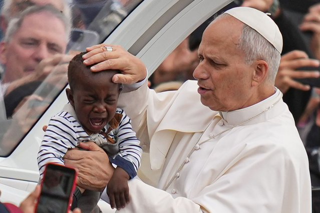 Pope Leo XIV blesses a child at the end of a Mass for the Jubilee of Migrants and Missionaries in St. Peter's Square at the Vatican, Sunday, October 5, 2025. (Photo by Alessandra Tarantino/AP Photo)
