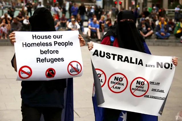 Supporters of the anti-Islam group Reclaim Australia hold placards during a rally in central Sydney, Australia, November 22, 2015. A few hundred anti-Islam and a similar number of anti-racism demonstrators held rallies in Sydney's Martin Place, as part of a national day of protest, with similar rallies in Melbourne and other cities, local media reported. (Photo by David Gray/Reuters)