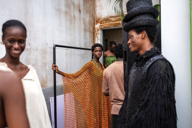 A model wearing a creation by Nigerian designer Bubu Ogisi at Iamisigo brand looks at another one as they get ready for a private presentation and performance to view the SS26 collection during Lagos Fashion Week in Lagos, on October 31, 2025. (Photo by Olympia de Maismont/AFP Photo)