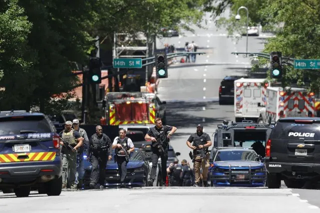 Law enforcement officers stage near the scene of an active shooter on Wednesday, May 3, 2023 in Atlanta. Atlanta police said there had been no additional shots fired since the initial shooting unfolded inside a building in a commercial area with many office towers and high-rise apartments. (Photo by Alex Slitz/AP Photo)