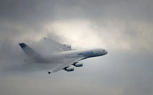 An EADS Airbus A380 flies over Le Bourget airport, near Paris on June 20, 2013 during the 50th International Paris Air show. (Photo by Eric Feferberg)