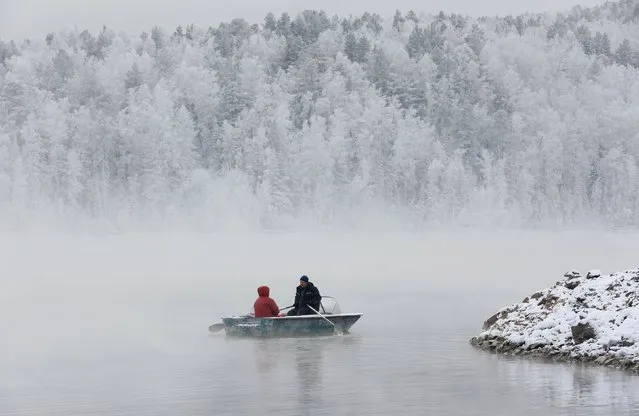 A man and a woman travel in a rowboat along the Yenisei River through a frosty fog in the Taiga district, with the air temperature at about minus 22 degrees Celsius (minus 7.6 degrees Fahrenheit), outside the Siberian city of Krasnoyarsk, Russia, November 22, 2015. (Photo by Ilya Naymushin/Reuters)