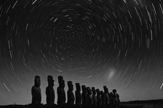 “Star Gazers”. On one of the last days while my family and I were on the island, the night happened to be very clear and I decided to try some long exposure shots. We got to Ahu Tongariki at about 10pm. When we stepped out of the car, my sister became very paranoid, and even screamed when a nearby lighthouse/tower lit up. I even got a bit paranoid in the dark with the hundreds year old moai, but everything turned out fine. The photo was a single 30 minute exposure. There was a bit too much sensor noise though. Next time I'll try to take a series of 30 second exposure and stack them. Location: Rapa Nui/Easter Island. (Photo and caption by Kevin Hu/National Geographic Traveler Photo Contest)