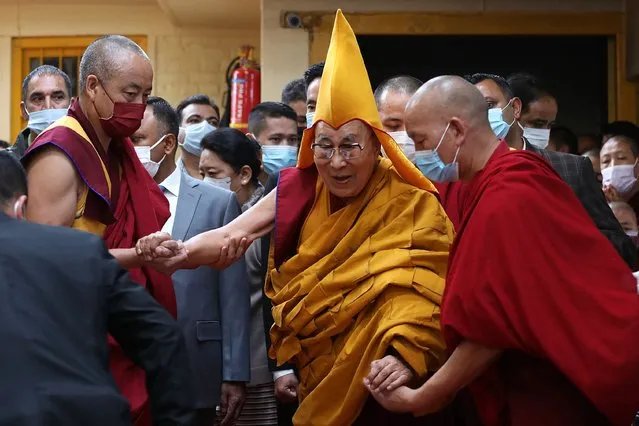 Tibetan spiritual leader Dalai Lama (C) arrives to attend a prayer ceremony offered to him for his long life at the Main Tibetan Temple in McLeod Ganj on May 24, 2023. (Photo by Sanjay Baid/AFP Photo)