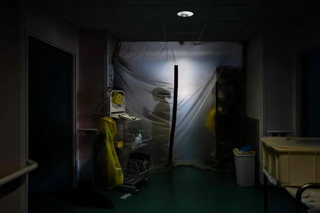 A medical worker prepares to enter into the Covid-19 unit of the “Hopital Prive de la Loire”, in Saint-Etienne, on November 6, 2020. (Photo by Jeff Pachoud/AFP Photo)