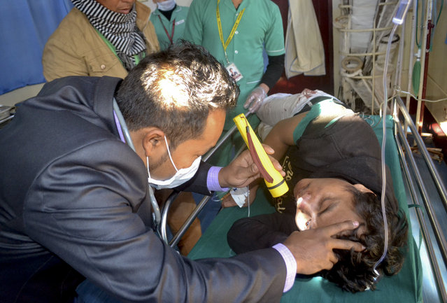 A doctor attends to a man who was injured after an earthquake at a hospital in Imphal, capital of the northeastern state of Manipur, India, Monday, January 4, 2016. (Photo by Bullu Raj/AP Photo)