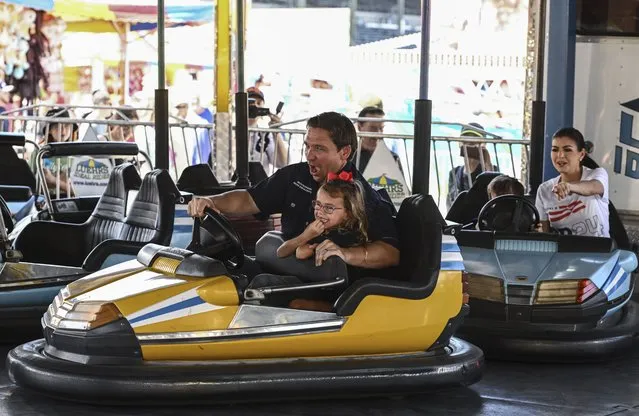 Republican presidential candidate and Florida Governor Ron DeSantis with his daughter Madison, and wife Casey in the rear, drive the bumper cars during the Iowa State Fair on August 12, 2023 in Des Moines, Ia. (Photo by Ricky Carioti/The Washington Post)