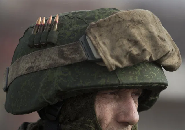 A Russia-backed rebel has bullets attached to his helmet in Debaltseve, Ukraine, Friday, Feb. 20, 2015. After weeks of relentless fighting, the embattled Ukrainian rail hub of Debaltseve fell Wednesday to Russia-backed separatists, who hoisted a flag in triumph over the town. The Ukrainian president confirmed that he had ordered troops to pull out and the rebels reported taking hundreds of soldiers captive.(AP Photo/Vadim Ghirda)