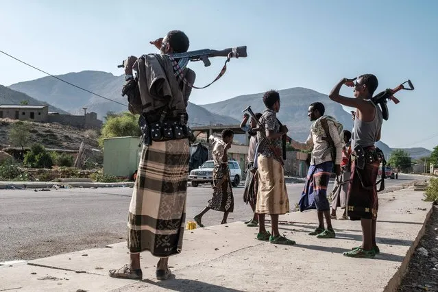 Members of the Afar militia stand in a checkpoint at the entrance of the town of Abala, 480 kilometers of Semera, Ethiopia, on June 08, 2022. The Afar region, the only passageway for humanitarian convoys bound for Tigray, is itself facing a serious food crisis, due to the combined effects of the conflict in northern Ethiopia and the drought in the Horn of Africa which have notably caused numerous population displacements. More than a million people need food aid in the region according to the World Food Programme. (Photo by Eduardo Soteras/AFP Photo)