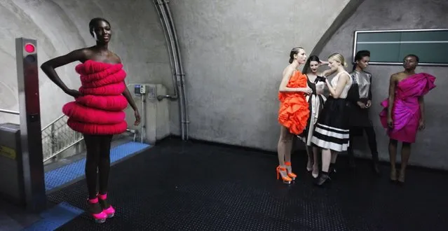 Models present creations in a subway station during Sao Paulo Fashion Week in Sao Paulo October 27, 2013. (Photo by Paulo Whitaker/Reuters)