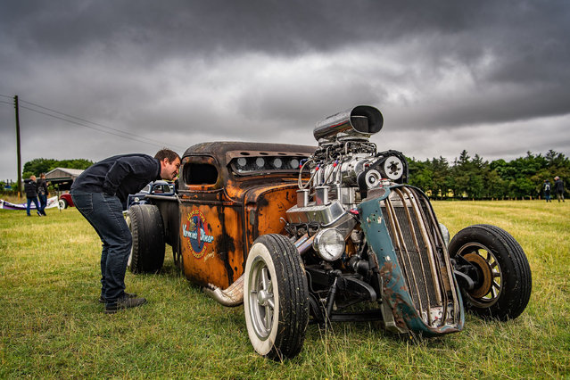 A man inspects a vehicle at the Yorkshire Motorsport Festival which is a three day event held in the north of England on June 27, 2021. (Photo by Charlotte Graham/Rex Features/Shutterstock)
