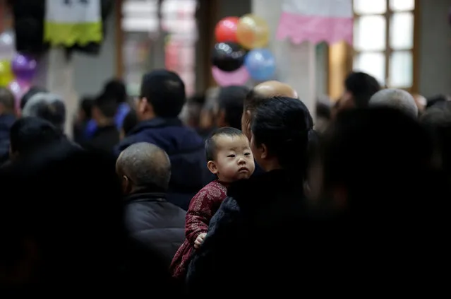 A villager holding her son attends a Christmas mass at a Catholic church on the outskirts of Taiyuan, North China's Shanxi province, December 25, 2016. (Photo by Jason Lee/Reuters)