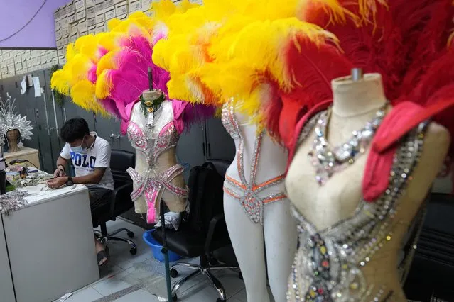 Workers prepare costumes for the Phuket Simon Cabaret in Phuket, southern Thailand, Tuesday, June 29, 2021. Thailand's government will begin the Phuket Sandbox scheme to bring the tourists back to Phuket starting July 1. The cabaret would not open immediately but its dancers might start with smaller shows in hotels and restaurants until larger number of tourists start to arrive. (Photo by Sakchai Lalit/AP Photo)