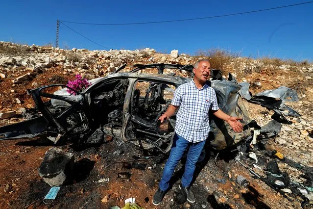 Samir Ayoub, uncle of three Lebanese girls killed along with their grandmother yesterday, by what he says was an Israeli airstrike that targeted their car in which they were traveling between Aytaroun and Aynata, speaks as he mourns them beside the burned car near the Lebanon and Israel border, in the outskirts of the southern town of Aynata, Lebanon on November 6, 2023. (Photo by Zohra Bensemra/Reuters)