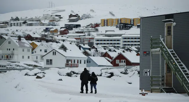 In this photo taken Thursday, February 4, 2016, asylum seekers leave the refugee camp in  Hammerfest, to walk to the town's centre, in northern Norway. (Photo by Alastair Grant/AP Photo)