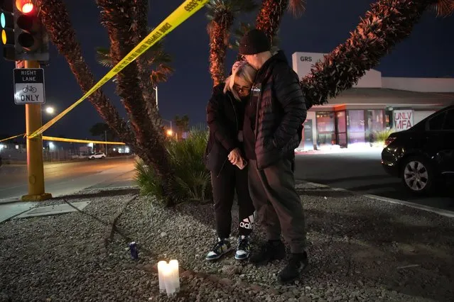 Sean Hathcock, right, kisses Michelle Ashley after the two left candles for victims of a shooting at the University of Nevada, Las Vegas, Wednesday, December 6, 2023, in Las Vegas. The two graduated from the school and live nearby. (Photo by John Locher/AP Photo)