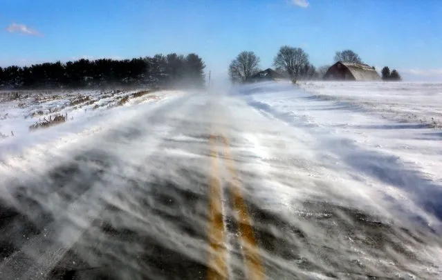 Drifting snow obscures a road near Mount Joy in Lancaster County, Pa., on Wednesday January 30, 2019. A bitter deep freeze is moving into the Northeast from the Midwest, sending temperatures plummeting and making road conditions dangerous. (Photo by Jacqueline Larma/AP Photo)