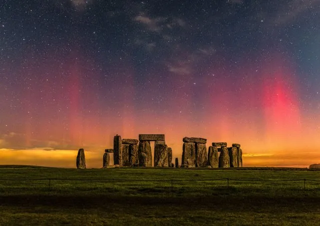 The northern lights made a brief appearance over Stonehenge in Wiltshire on Saturday evening, November 4, 2023. The image consists of two photos, a 16-second exposure of the sky and a two-minute exposure of the foreground, merged together to reveal more detail than what the naked eye can see in darkness. (Photo by Nick Bull/Picture Exclusive)