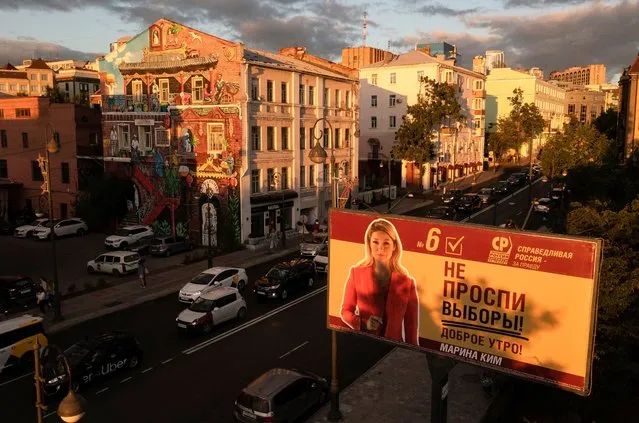 A campaign poster of Spravedlivaya Rossiya - Za pravdu (A Just Russia – For Truth) party candidate for parliamentary election is seen at sunset in Vladivostok, Russia on September 12, 2021. (Photo by Tatiana Meel/Reuters)