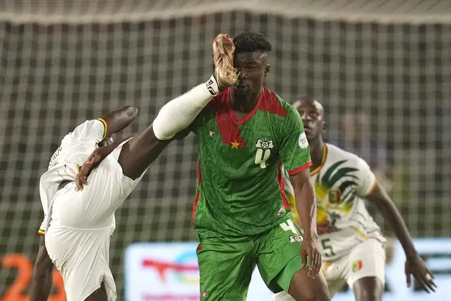 Mali's Diadie Samassekou, left, in action against Burkina Faso's Adamo Nagalo during the African Cup of Nations round of 16 soccer match between Mali and Burkina Faso, at the Amadou Gon Coulibaly stadium in Korhogo, Ivory Coast, Tuesday, January 30, 2024. (Photo by Themba Hadebe/AP Photo)