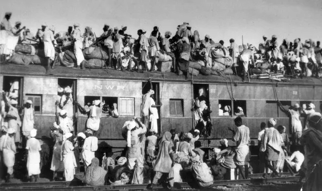 Muslim refugees sit on the roof of an overcrowded coach railway train in trying to flee India near New Delhi on September 19, 1947. About 5 million Muslims migrated from India to Pakistan after India gained its independence on Aug. 15. (Photo by AP Photo/File)