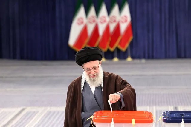 Iran's supreme leader Ayatollah Ali Khamenei casts his ballot during the parliamentary and key clerical body elections at a polling station in Tehran on March 1, 2024. Polling stations in Iran opened on March1 for voting to select members of parliament and a key clerical body, amid fears of a low turnout and with conservatives expected to tighten their grip on power. (Photo by Atta Kenare/AFP Photo)