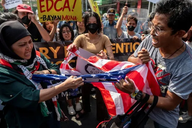 Filipino activists tear a U.S. flag during a protest against the visit of U.S. Secretary of State Antony Blinken, in Manila, Philippines on March 19, 2024. (Photo by Lisa Marie David/Reuters)