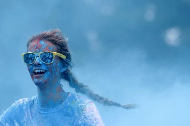 A participant runs through colored powder as she takes part in the Get Rainbowed run in Prague May 23, 2015. (Photo by David W. Cerny/Reuters)