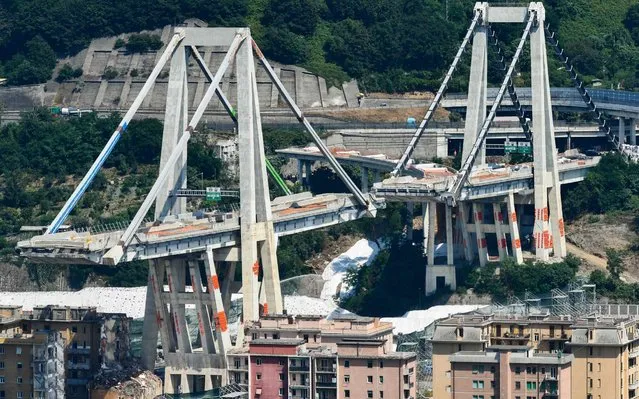 A general view shows water being spread on the ground before the remaining eastern pylons of Genoa's Morandi motorway bridge are being blown up with explosives, on June 28, 2019 in Genoa. Some of the remains of Genoa's Morandi motorway bridge are set to be destroyed on June 28 almost eleven months after its partial collapse during a storm killed 43 people and injured dozens. (Photo by Vincenzo Pinto/AFP Photo)