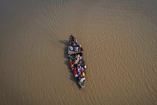 People cross the Brahmaputra river in a boat to reach a polling booth during the second round of voting in the six-week-long national election in Morigaon district, about 77km (48 miles) from Guwahati, India, Friday, April 26, 2024. (Photo by Anupam Nath/AP Photo)