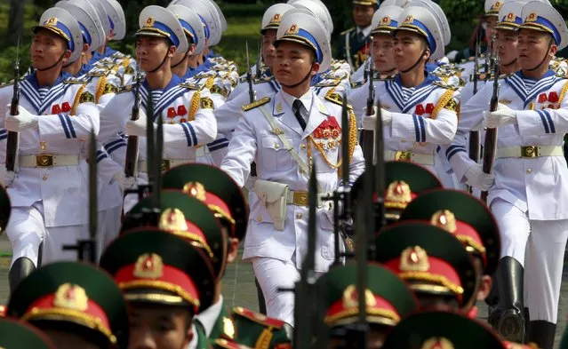 Members of military honour guard march during a welcoming ceremony for Laos' Communist Party General Secretary and President Bounnhang Vorachit at the Presidential Palace in Hanoi, April 25, 2016. (Photo by Reuters/Kham)