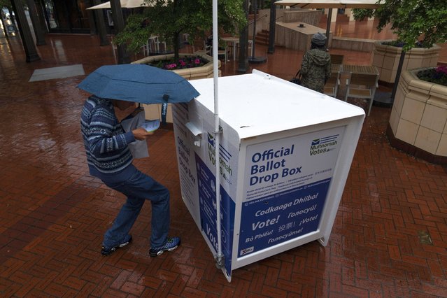 A person drops off their vote-by-mail ballot at a dropbox in Pioneer Square during primary voting on Tuesday, May 21, 2024, in Portland, Ore. (Photo by Jenny Kane/AP Photo)