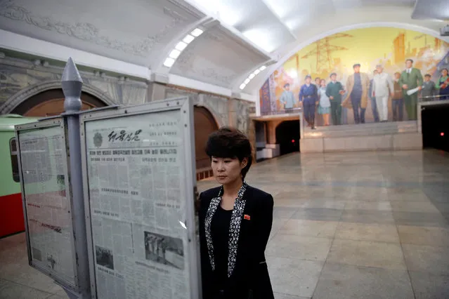 A woman reads newspapers displayed inside a subway station visited by foreign reporters on a government organised tour in central Pyongyang, North Korea May 7, 2016. (Photo by Damir Sagolj/Reuters)