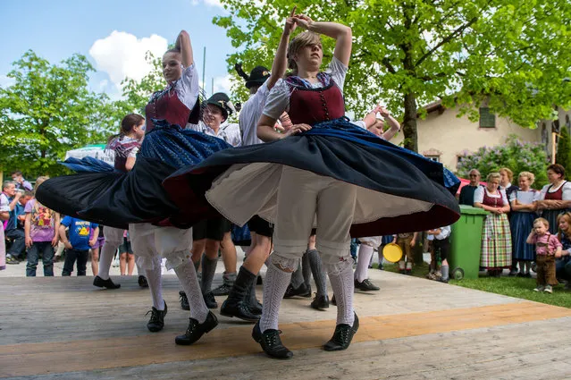 Traditionally dressed dancers perform during the May Day celebrations in Lofer in the Austrian province of Salzburg, on Thursday, May 1, 2014. (Photo by Kerstin Joensson/AP Photo)