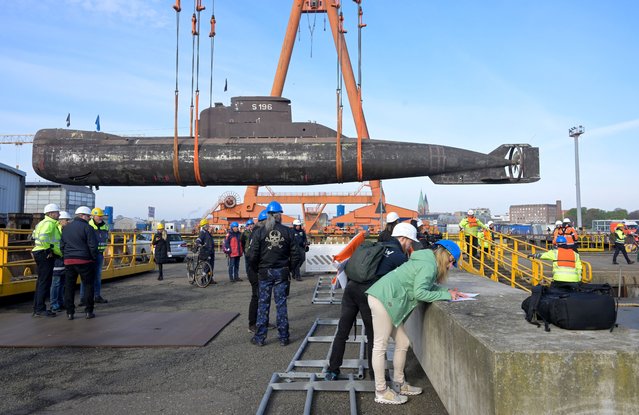 German submarine U17 is lifted by a crane to load it on a pontoon at a shipyard in Kiel, Germany on April 28, 2023. (Photo by Fabian Bimmer/Reuters)