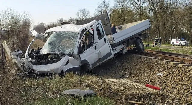 A damaged van is seen on the railway tracks after a fatal collision with a train in Mindszent, Hungary on Tuesday, April 5, 2022. Police say a train has struck a vehicle in southern Hungary and derailed, leaving several people dead and others injured. The accident occurred just before 7 a.m. in the town of Mindszent. (Photo by Csongrad-Csanad County Police via AP Photo)