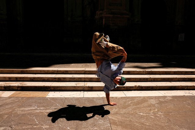 Spanish breakdancer Laura Garcia, 29, (B-Girl RawLaw) performs on a street, in downtown Granada, Spain on July 22, 2024. (Photo by Jon Nazca/Reuters)