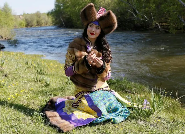 A model of the "Altyr" fashion theatre, dressed in a Khakas national costume, poses during a photo session, as a part of the rehearsal for the Tun-Pairam traditional holiday (The Holiday of the First Milk) celebration at a museum preserve outside Kazanovka village near Abakan in the Republic of Khakassia, Russia, May 28, 2016. (Photo by Ilya Naymushin/Reuters)