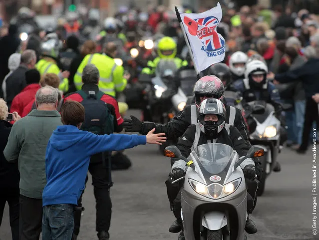 Bikers passes along the High Street on March 18, 2012 in Royal Wootton Bassett, England