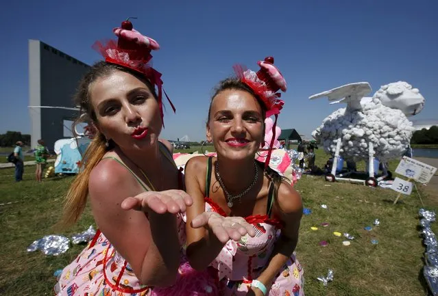 Participants pose for a picture during preparations before the Red Bull Flugtag Russia 2015 competition in Moscow, Russia, July 26, 2015. Enthusiasts competed in disciplines on the longest distance of the flight, on the creativity of self-made aircrafts and on the originality of the performance in an attempt to win the contest, according to organizers. (Photo by Sergei Karpukhin/Reuters)
