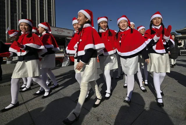 South Korean children wearing Santa Claus outfits smile as they wait their turn for a performance during a ceremony to launch a year-end fundraising campaign of the Salvation Army at Gwanghwamun square in Seoul on November 29, 2019. The Salvation Army launched its year-end charity campaign for underprivileged people from November 29 to December 31. (Photo by Jung Yeon-je/AFP Photo)