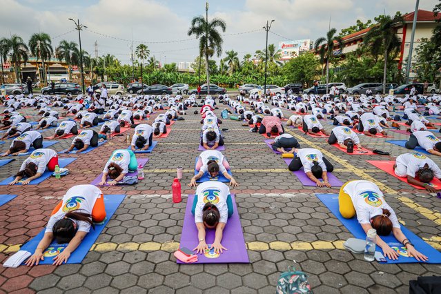 Yoga practitioners take part in a mass yoga session on the 10th International Day of Yoga at Batu Caves, Malaysia, on June 21, 2024. (Photo by Annice Lyn/Reuters)