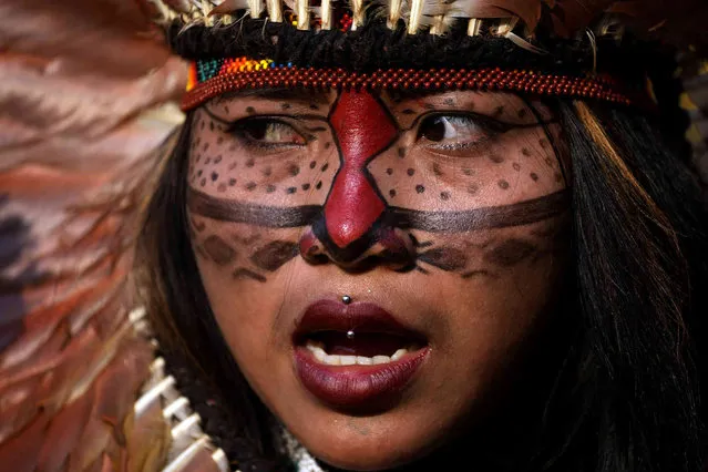 An Indigenous woman attends a women's march to protest the policies of Brazilian President Jair Bolsonaro and in favor of women's rights and the demarcation of Indigenous lands in Brasilia, Brazil, Friday, September 10, 2021. (Photo by Eraldo Peres/AP Photo)