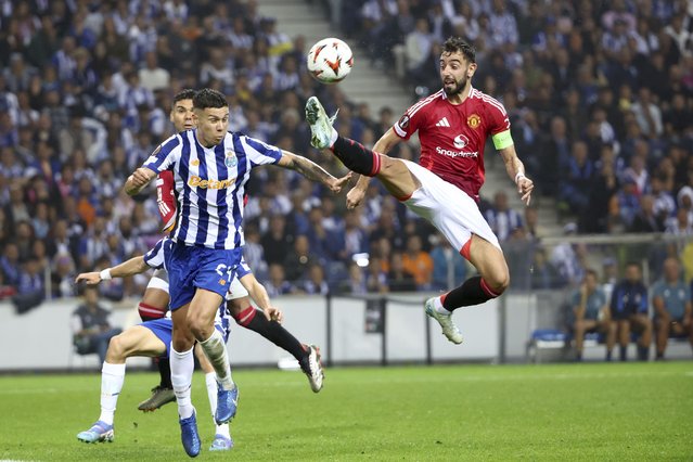 Manchester United's Bruno Fernandes, right, reaches for the ball too high and close to the head of Porto's Nehuen Perez to see a second yellow card and be sent off, during a Europa League opening phase soccer match between FC Porto and Manchester United at the Dragao stadium in Porto, Portugal, Thursday, October 3, 2024. (Photo by Luis Vieira/AP Photo)