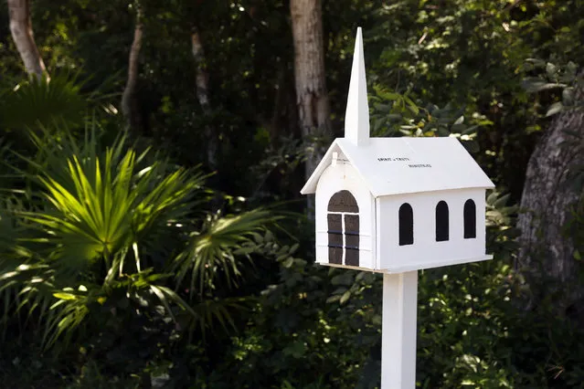 A mailbox in the shape of a church is seen outside a chapel along the highway US-1 in the Lower Keys near Key Largo in Florida, July 11, 2014. (Photo by Wolfgang Rattay/Reuters)