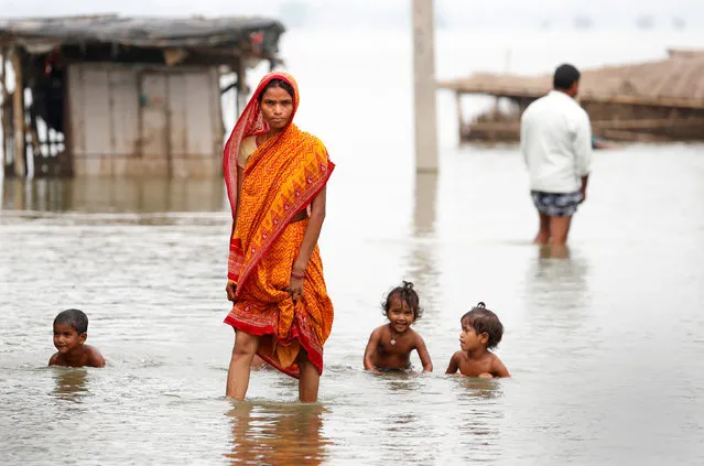 A woman walks through a flooded village in Motihari, Bihar State, India August 23, 2017. (Photo by Cathal McNaughton/Reuters)